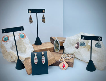 Multiple sets of earrings and pendants from the One of a Kind jewelry collection